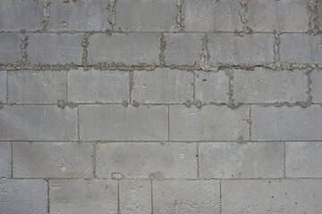   A wall of gray rectangular blocks. Texture for background.