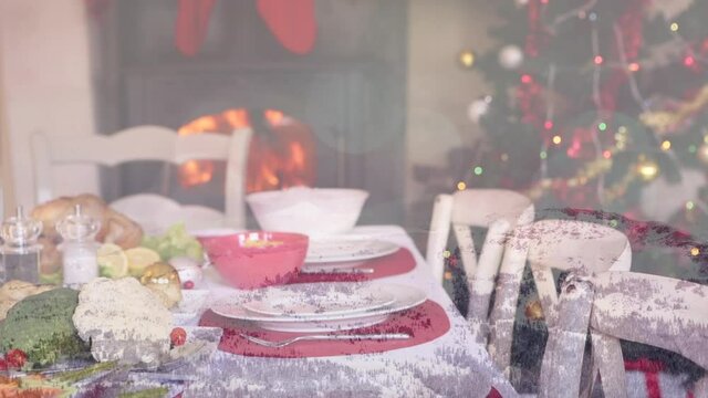 Animation of table set for christmas meal over winter scenery
