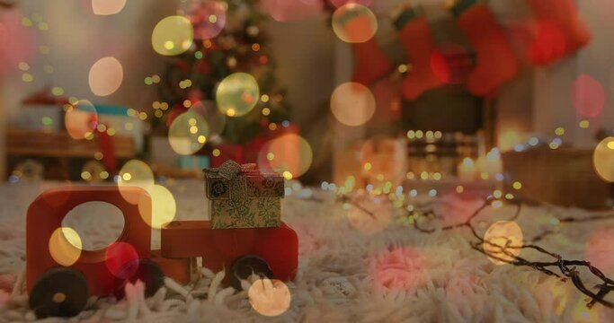 Animation of christmas flickering fairy lights over wooden toy in living room