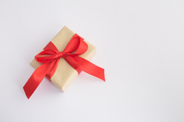 Closeup on gift  with red ribbon on the white background with copy space