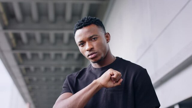 Black man with respect gesture outdoors in city, black lives matter concept.