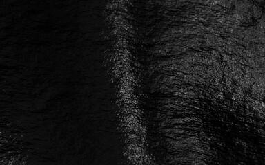 Black foil background with highlights and uneven texture
