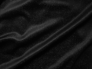Shiny black crumpled fabric texture. Elegant cloth background
