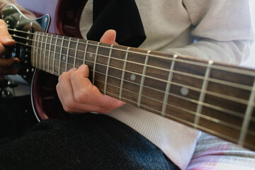 Fototapeta na wymiar close-up of a young man playing electric guitar