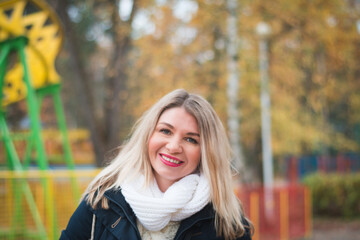 A beautiful girl is photographed in the autumn on the street