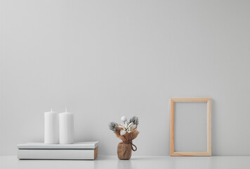 Frame, white candles and New Year's decor on a white background. Copy space, mock up.