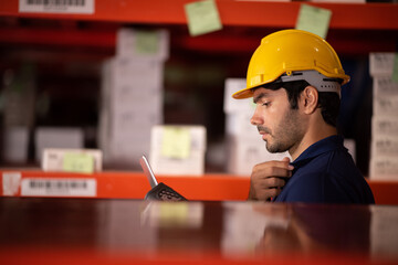 warehouse worker using bar code scanner to analyze newly arrived goods for further placement in...