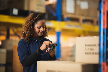 warehouse worker using bar code scanner to analyze newly arrived goods for further placement in...