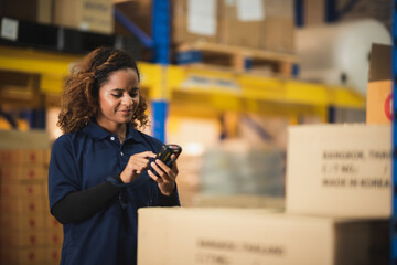 warehouse worker using bar code scanner to analyze newly arrived goods for further placement in...
