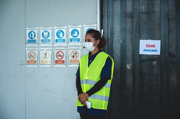 supervisor measuring temperature of workers with thermometer at warehouse factory, construction...