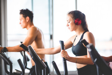 Fototapeta premium beautiful girl and her well-built boyfriend trainer, They are happy to see each othr in the gym. Young people are ready to start their workout
