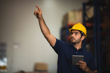 Man warehouse worker with a tablet