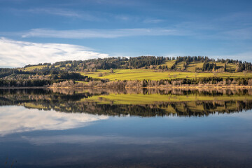 landscape in autumn mood at lake Gruentensee with Gruenten summit in background, upper Allgaeu near Nesselwand, Bavaria, Germany