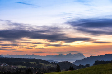 Naklejka na ściany i meble Sunset over Mount Saentis in Swiss Alps with Bregenzerwald, Austria, Vorarlberg, in foreground