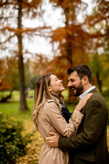 Young couple walking in the autumn park