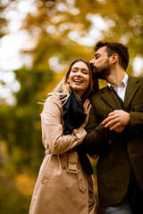 Young couple walking in the autumn park