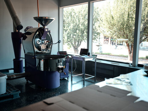 Coffee House. Interior Of Little Coffee Roasting Factory On A Daytime. Roasting Coffee Beans In A Modern Coffee Roaster Machine