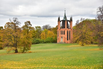 Krasny Dvur Park is a garden adjacent to the castle of the same name, shown in autumn with...