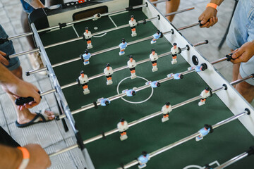 Fototapeta premium guys are playing table football view from above. table football soccer with white and blue players