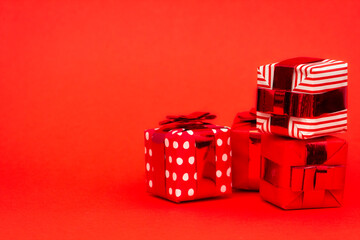 Different gift boxes with a bow isolated on redbackground for new year or christmas 