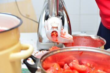 Tomato skins fall into a separate bowl.