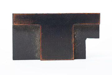 The letter T in antique letterepress type isolated on a white background