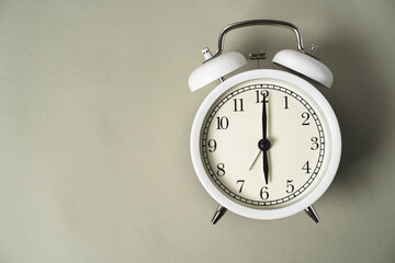 alarm clock with a dial lies on a gray background, business idea, time is money