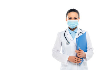 African american doctor in white coat and medical mask holding paper folder isolated on white