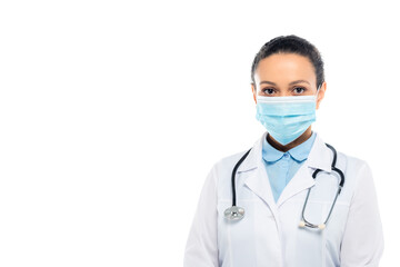 Fototapeta premium African american doctor in medical mask and stethoscope looking at camera isolated on white
