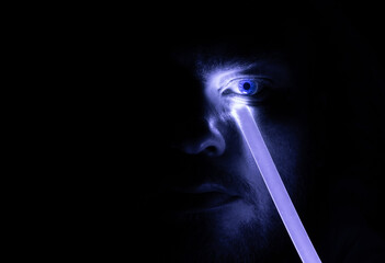 Portrait of man with neon light stick . Blue eye in dark. Art design.