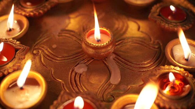 Macro shot showing colorful earthenware diya oil lamps with a little cotton wick to burn oil for light often used as decoration on the hindu festival of diwali showing the victory of good over evil
