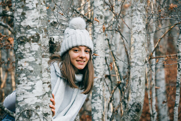 young teenage girl posing in birch forest