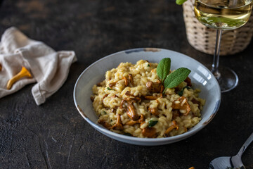 Risotto with chanterelles and saga leaves. Risotto and white wine