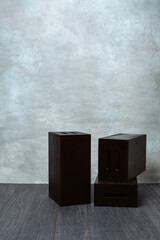 Grey textured backdrop and wooden posing boxes flooring in studio

