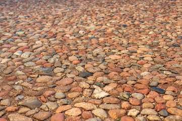 Stone road with stones of different colors, natural light