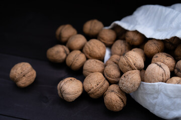 Walnuts in a bag on a black background
