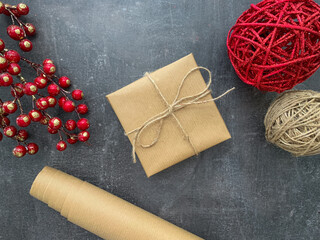 Simple gift box wrapped in craft paper on wooden background.