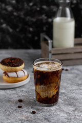 Glass of hot coffee with milk. Coffee and donuts