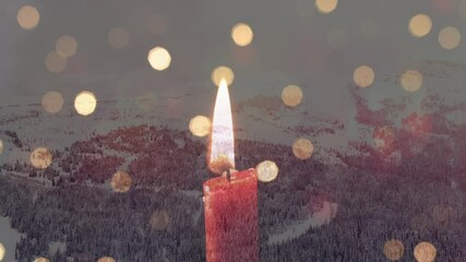 Digital composition of burning candle and spots of light against snow landscape - Powered by Adobe
