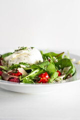 Salad with Italian burrata cheese, arugula, cherry tomatoes, parmesan and raspberry