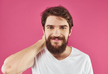 Cute guy with beard on pink background close-up portrait cropped view