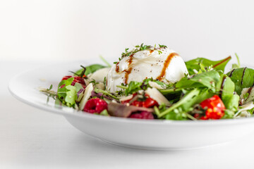Salad with Italian burrata cheese, arugula, cherry tomatoes, parmesan and raspberry with balsamic glaze