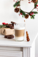 Winter latte coffee in glass with star shaped christmas cookies . Christmas concept
