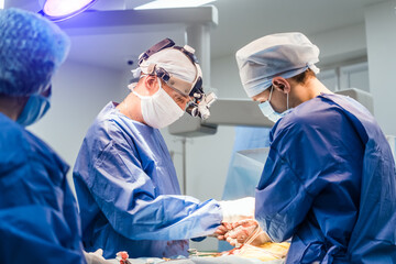 Doctors perform minimally-invasive surgeon using a robotic device. Up to date operation room.