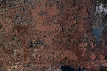The texture of an old rusty metal barrel.
