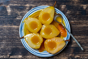 Baked pears in orange juice, close up. Delicious dessert.