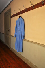 Vintage nurses uniform hanging in a corridor of an old hospital.
