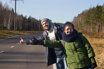 Journey. Tourism. Tourists hitchhike, catch a car on the road