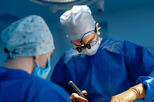 Operation in hospital. Health care concept. Neurosurgeons at work. Selective focus. Medical room background.