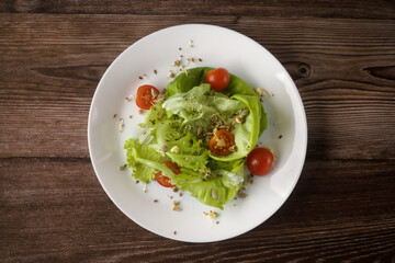 Healthy food - green salad, cherry tomatoes, sprouted wheat and bean.